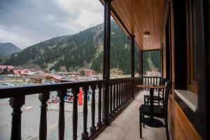 a balcony with fire hydrants and a table and chairs at Turkuaz Apart in Uzungöl