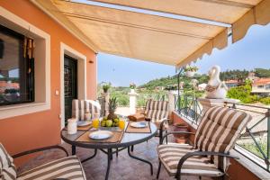 a patio with a table and chairs on a balcony at Harmony Marathias luxury apartment in Marathias