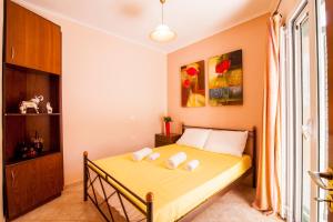 a bedroom with a bed with three pillows on it at Harmony Marathias luxury apartment in Marathias
