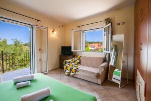 a living room with a couch and a large window at Harmony Marathias luxury apartment in Marathias +10 photos