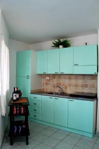 a kitchen with blue cabinets and a sink at Villaggio Mondial Camping in Metaponto