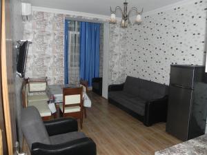 a living room with a couch and a table at Apartment Rustaveli 59 in Batumi