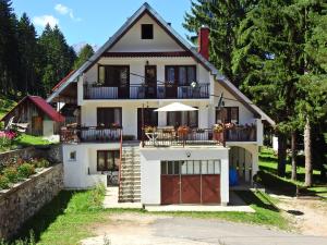 a large white house with a porch and a balcony at Apartments Vuković in Žabljak
