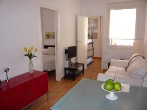 uma sala de estar com um sofá branco e um armário vermelho em Apartament Conde Güell em Barcelona