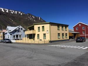 um edifício amarelo no lado de uma rua em Isafjordur Hostel em Isafjordur