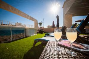 two glasses of white wine sitting on a table at Residhome Nice Promenade in Nice