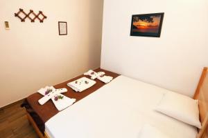 a bedroom with a bed with towels on it at Dalyan Pension in Dalyan