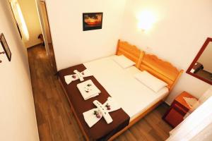 a small room with a bed and two crosses on a table at Dalyan Pension in Dalyan