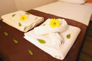 two towels with a flower on them on a bed at Dalyan Pension in Dalyan