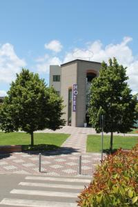 a building with two trees in front of it at Hotel Portavaldera in Peccioli