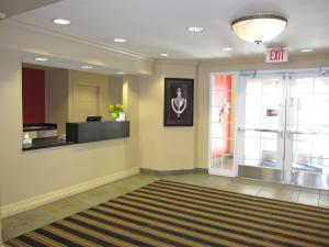 an empty lobby with a waiting room and an exit at Extended Stay America Suites - San Jose - Edenvale - South in San Jose