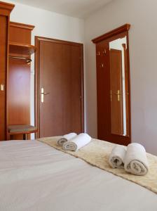a bedroom with a bed with towels on it at Rooms Nadia3 in Baška +3 photos