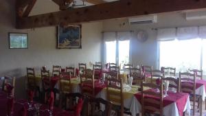 a dining room with a table and chairs with red and yellow at Le Saint Victor in Mirabel-aux-Baronnies