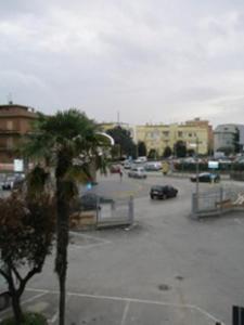 a parking lot with a palm tree in a parking lot at Villa Marietta in Civitanova Marche