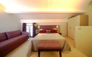 a bedroom with a bed and a couch at Residence Hotel Le Viole in Rimini