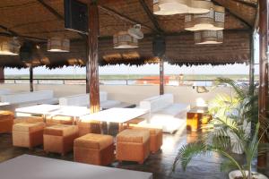 a restaurant with white furniture and a view of the ocean at Rio Boutique Hotel in Pucallpa