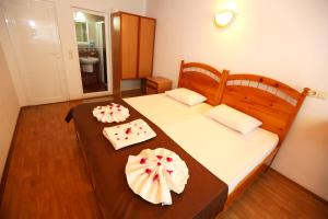 two beds in a room with two cakes on them at Dalyan Pension in Dalyan