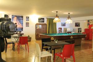 a room with a pool table and red chairs at Salenthouse in Racale