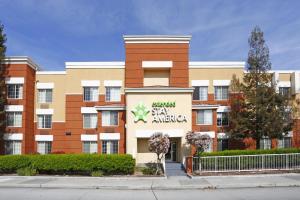 an apartment building with a sign for a stay embassy at Extended Stay America Suites - San Jose - Downtown in San Jose