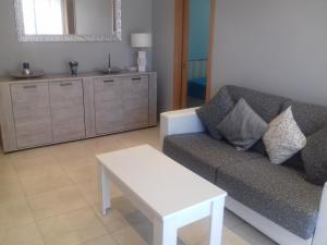 a living room with a couch and a table at Apartamento Delfos in Salou