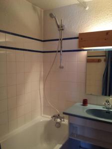 a bathroom with a shower and a tub and a sink at Saint-Roch Piste in Val dʼIsère +23 photos