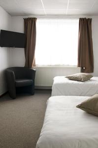 Postel nebo postele na pokoji v ubytování Hotel Halleux
