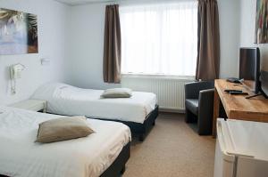 Postel nebo postele na pokoji v ubytování Hotel Halleux
