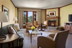 a living room with a couch and a fireplace at Four Seasons Resort Vail in Vail