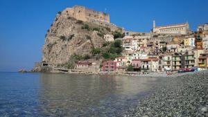 a town on a hill next to a body of water at Scilla Beach in Scilla