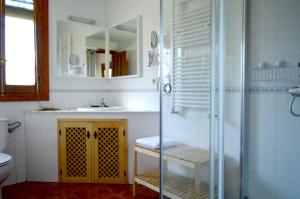 a bathroom with a glass shower and a sink at Casa Valeriana in Navaconcejo