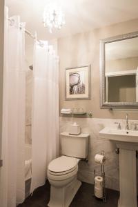 a bathroom with a toilet and a sink and a mirror at 3 West Club in New York