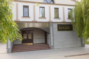 a building with a sign that reads deluge at Boutique Hotel Deluxe in Kamianets-Podilskyi