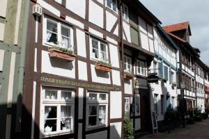 a brown and white building with windows on a street at Altstadt-Refugium in Hameln