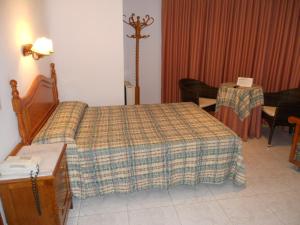 Postel nebo postele na pokoji v ubytování Hotel Paris