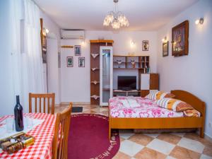 a bedroom with a bed and a table and a room at Guest House Jeljenic in Dubrovnik
