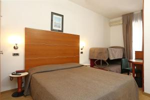 Postel nebo postele na pokoji v ubytování Hotel Corticella + 37 fotografií