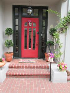 a red door on a house with potted plants at My Rosegarden Guest Rooms in San Francisco