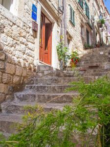 a set of stone stairs leading to a red door at Guest House Jeljenic in Dubrovnik