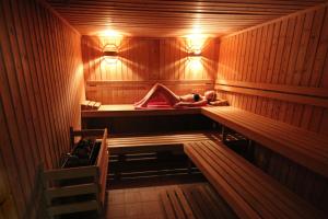 a woman is laying in a sauna at Clube Porto Mos - Sunplace Hotels & Beach Resort in Lagos