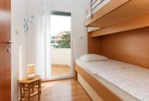 Postel nebo postele na pokoji v ubytování Beachfront Family Escape, Ciovo
