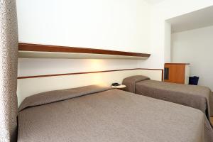 Llit o llits en una habitació de Hotel Corticella
