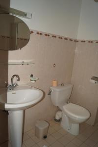 a bathroom with a sink and a toilet and a mirror at L'Allegria in Casaglione