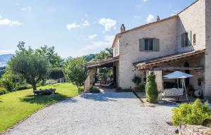 an external view of the farmhouse with a garden at Poggio Dei Prugnoli in Tavoleto