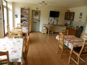 a kitchen and dining room with tables and chairs at Agroturystyka Podzamcze in Krzeszowice