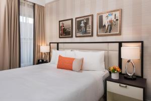 
a hotel room with a large bed and a large mirror at Inn at Union Square in San Francisco
