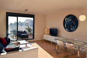 a living room with a glass table and a television at Sky Home Peñiscola in Peniscola
