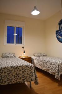 a bedroom with two beds and a window at Sky Home Peñiscola in Peniscola