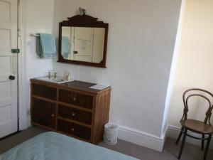 a bathroom with a sink and a mirror on the wall at Staigue Fort House in Caherdaniel