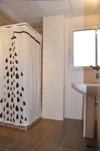 a bathroom with a shower curtain and a sink at Sky Home Peñiscola in Peniscola