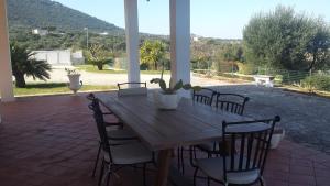 a wooden table and chairs on a patio at Appartamento Giardinelli - Giulia in Fasano